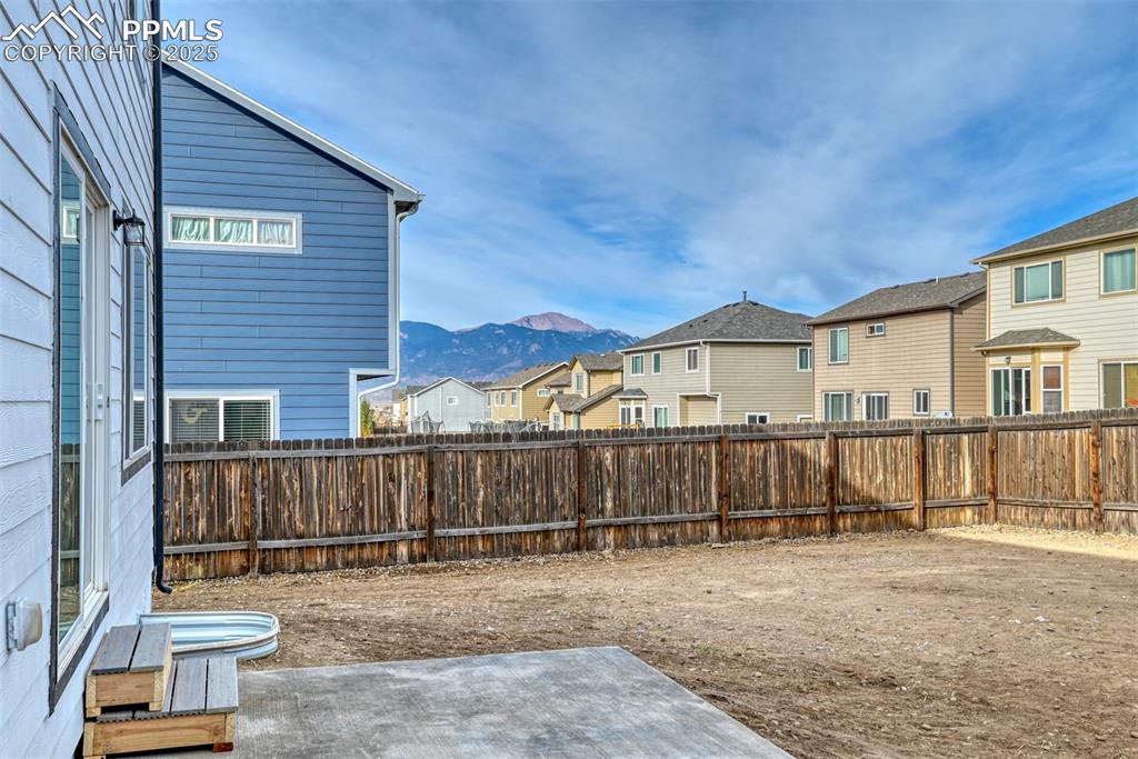 Image 43 of 45: Fenced backyard with a residential view, a patio, and a mountain view