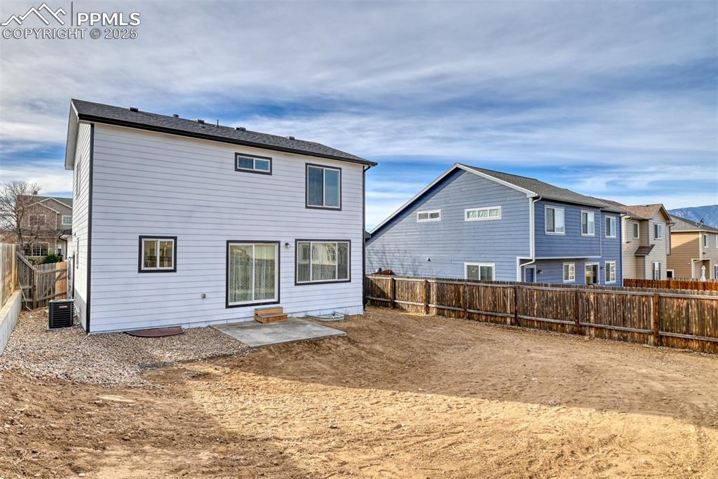 Image 45 of 45: Rear view of house with a patio area, a fenced backyard, and a residential