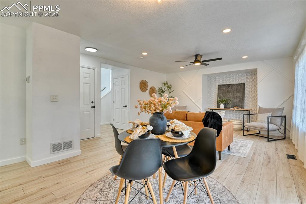Image 9 of 45: Dining area featuring ceiling fan, light wood-style floors, recessed lighti