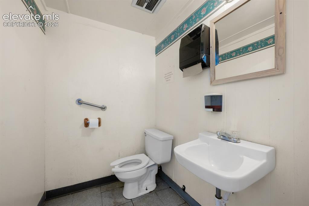 Image 10 of 50: Public Bathroom in Laundromat
