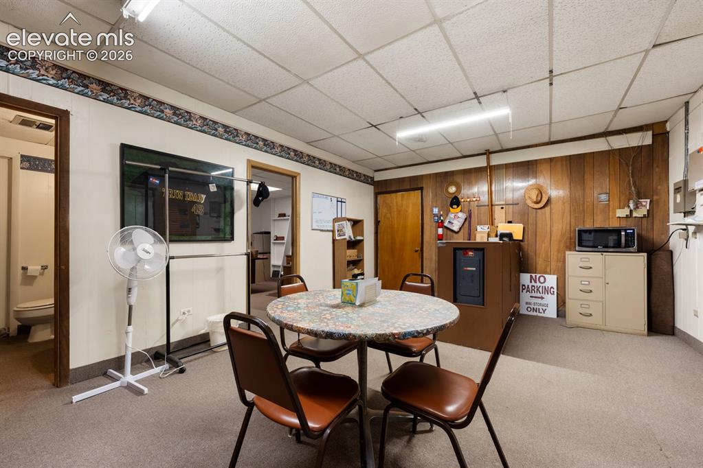 Image 13 of 50: This staff lounge is in the laundromat space