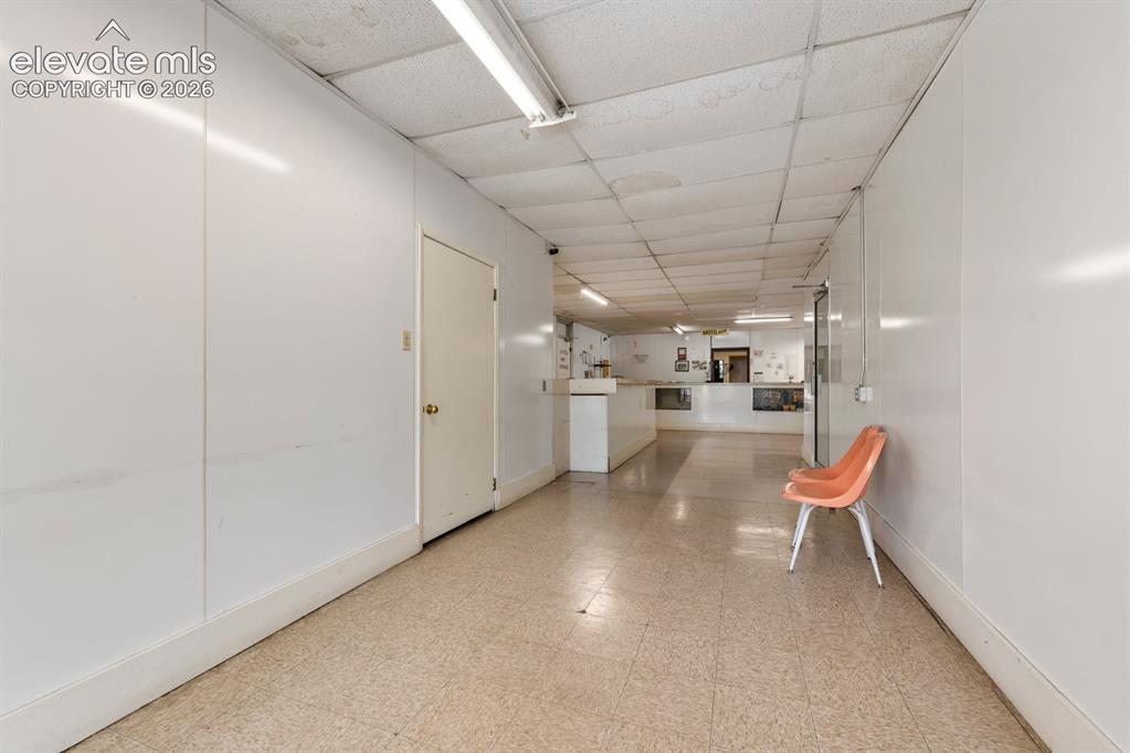 Image 16 of 50: Hallway from the parking lot into laundromat or check in to motel room