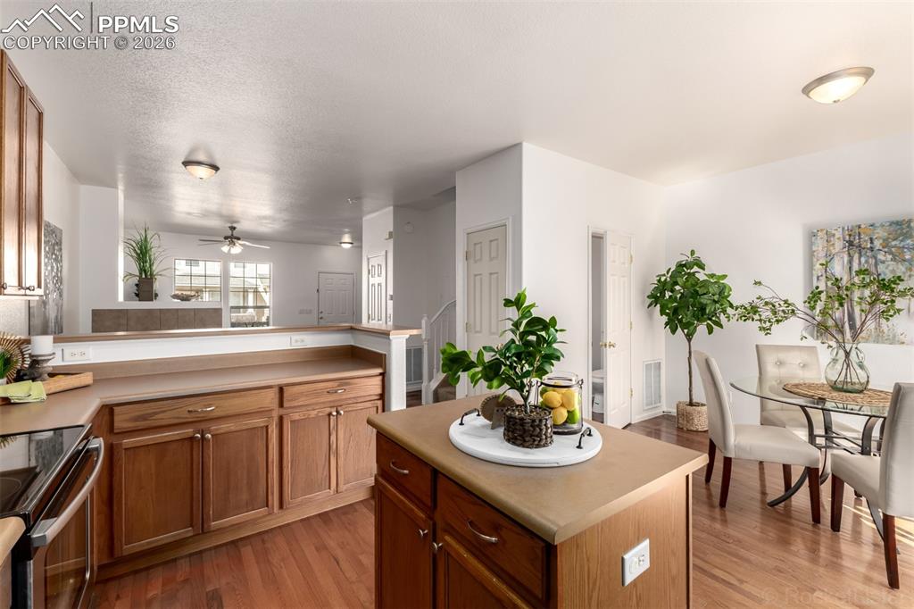 Image 10 of 33: Stainless steel appliances, light countertops, light wood-style flooring an