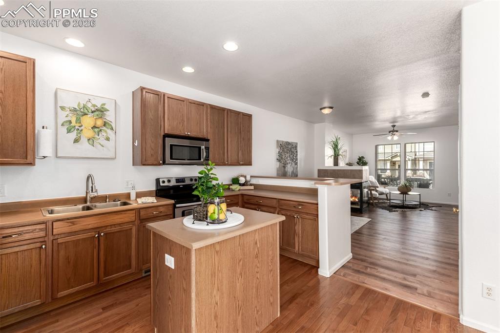 Image 12 of 33: Kitchen featuring stainless steel appliances, light countertops, a kitchen 