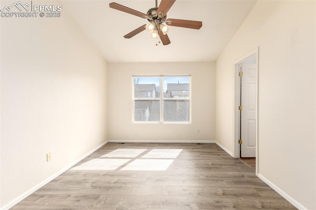 Image 17 of 33: Primary bedroom with vaulted ceiling, LVP floors and an en-suite bathroom 
