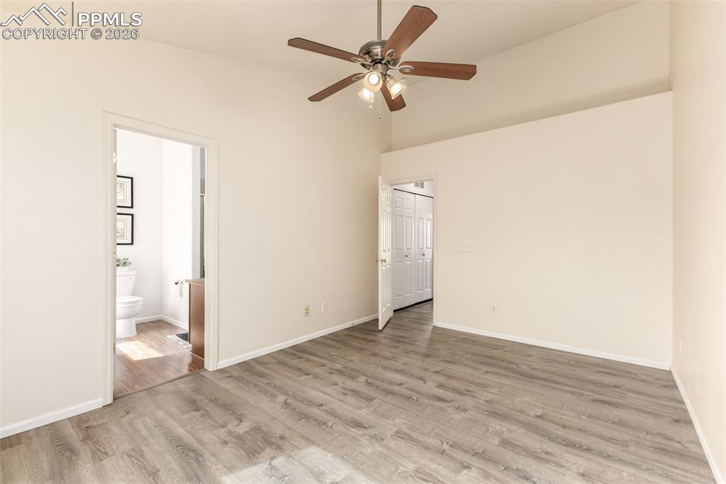 Image 18 of 33: Primary bedroom with vaulted ceiling, LVP floors and an en-suite bathroom 