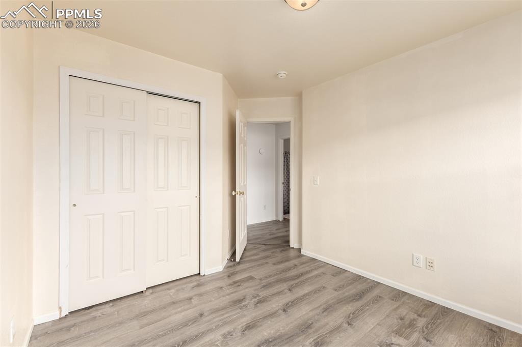 Image 22 of 33: Second bedroom with LVP flooring