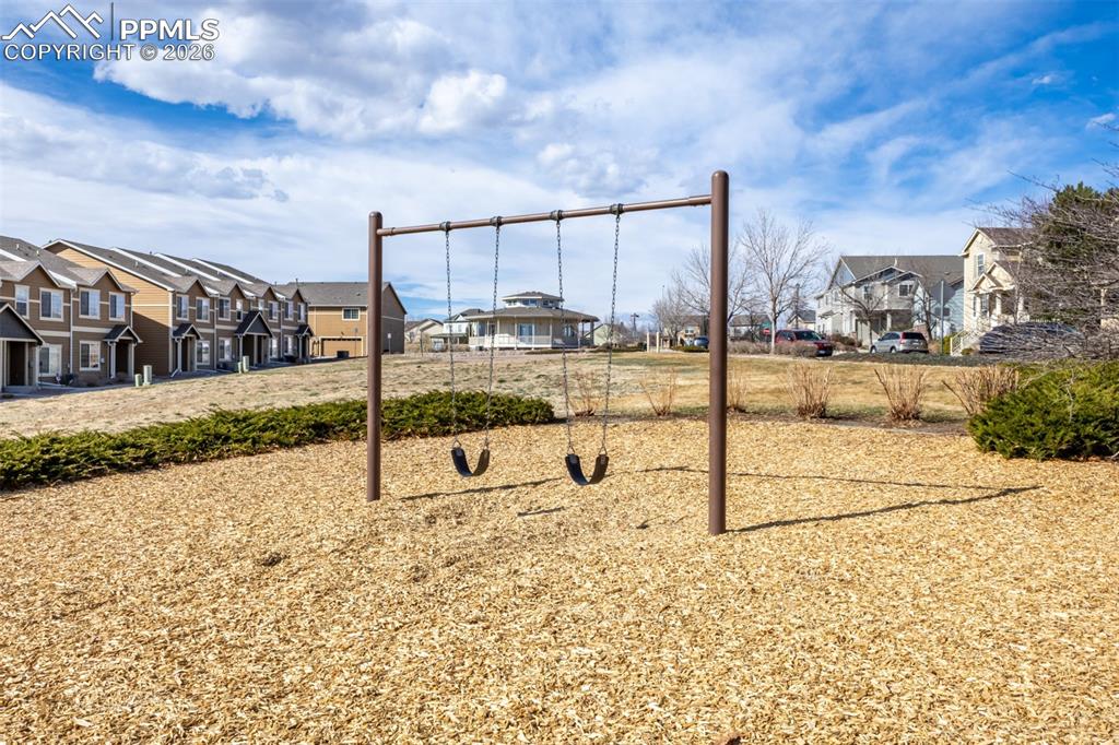 Image 32 of 33: Community jungle gym with a residential view