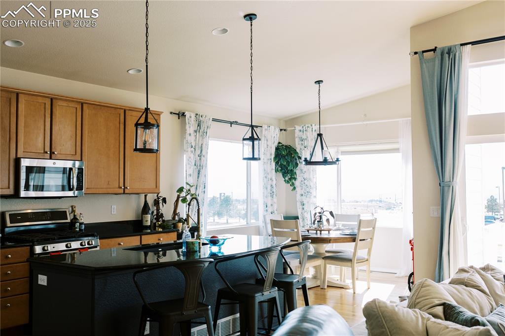 Image 12 of 36: Kitchen featuring appliances with stainless steel finishes, dark countertop