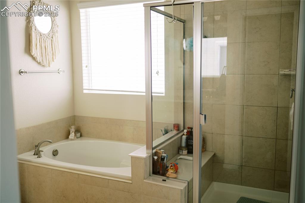 Image 20 of 36: Full bath featuring a bath and a stall shower