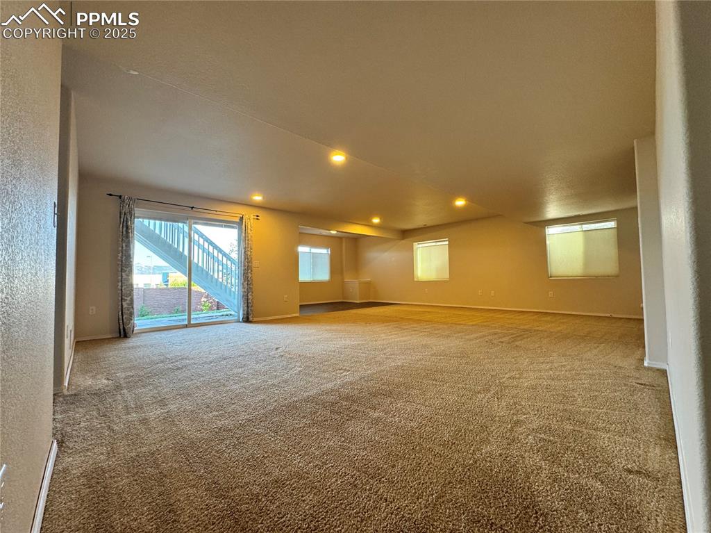 Image 28 of 36: Empty room with carpet flooring and recessed lighting