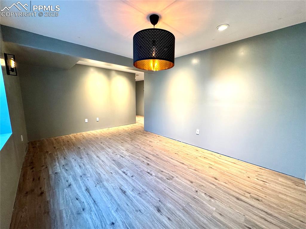 Image 34 of 36: Spare room with wood finished floors