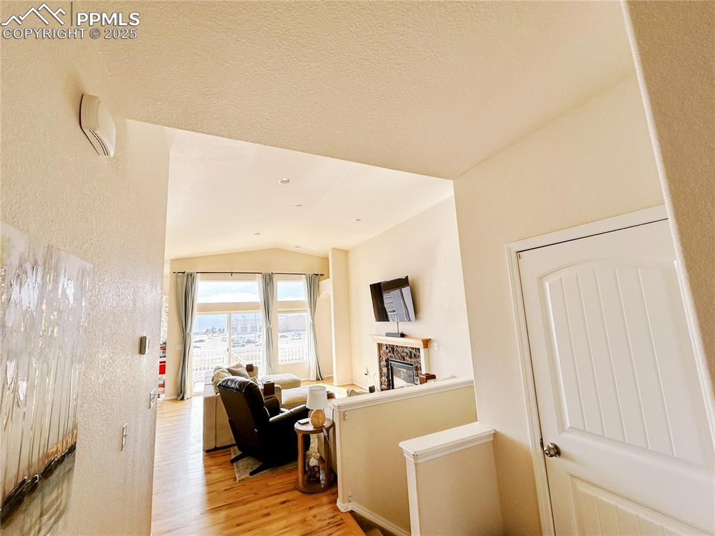 Image 6 of 36: Hall featuring lofted ceiling and light wood-type flooring