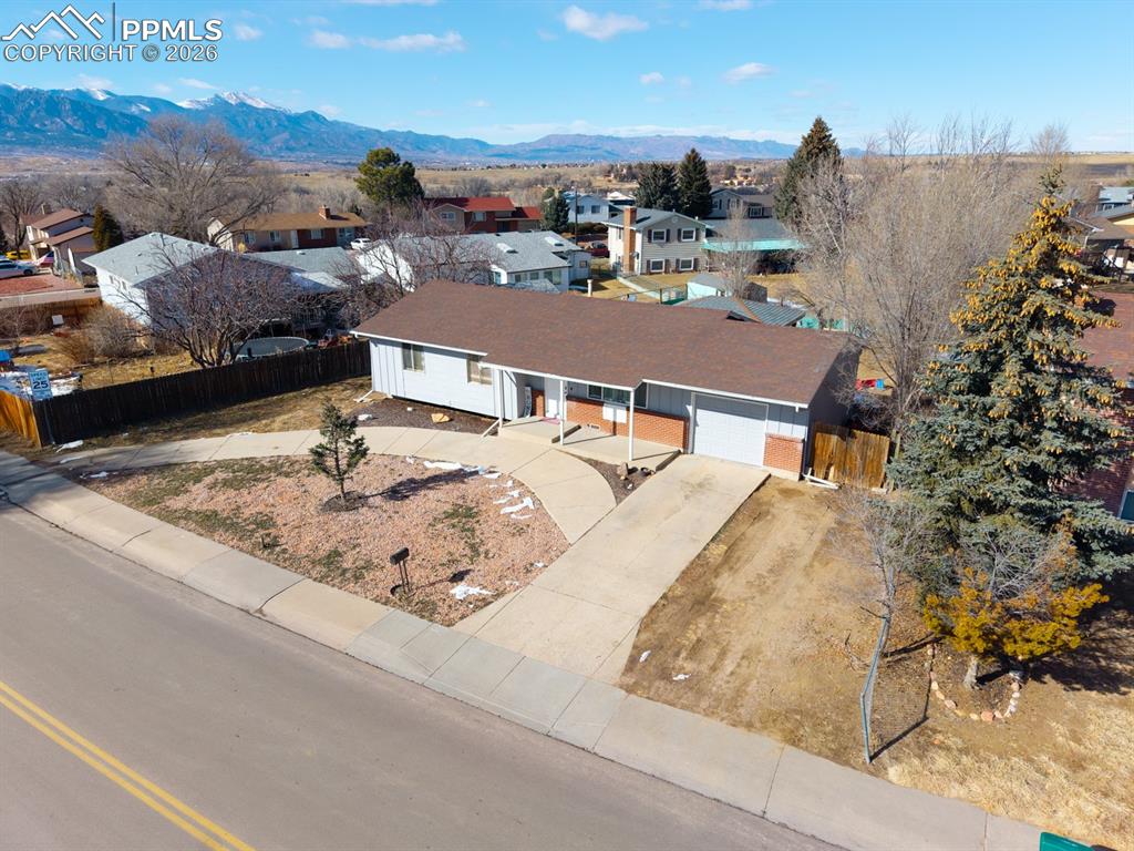 Image 3 of 37: Aerial perspective of suburban area featuring a mountain backdrop