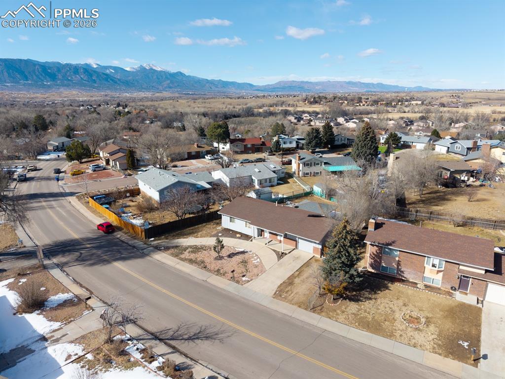 Image 4 of 37: Aerial perspective of suburban area featuring a mountain backdrop