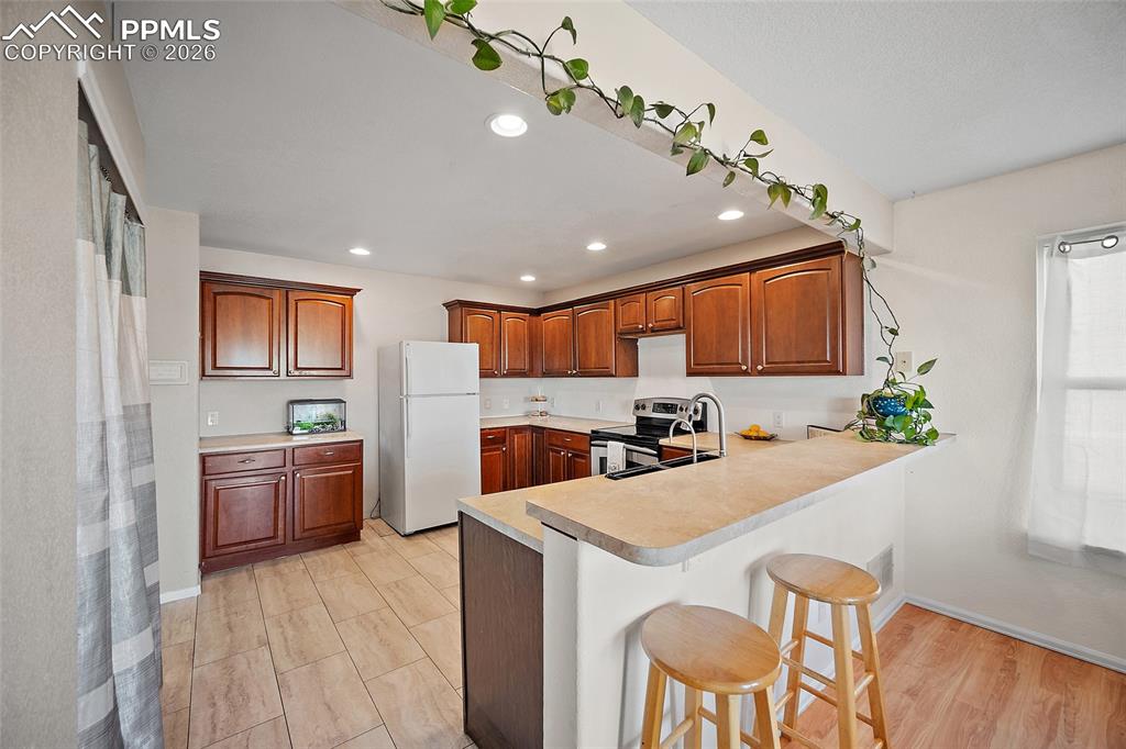 Image 11 of 47: Kitchen featuring a breakfast bar