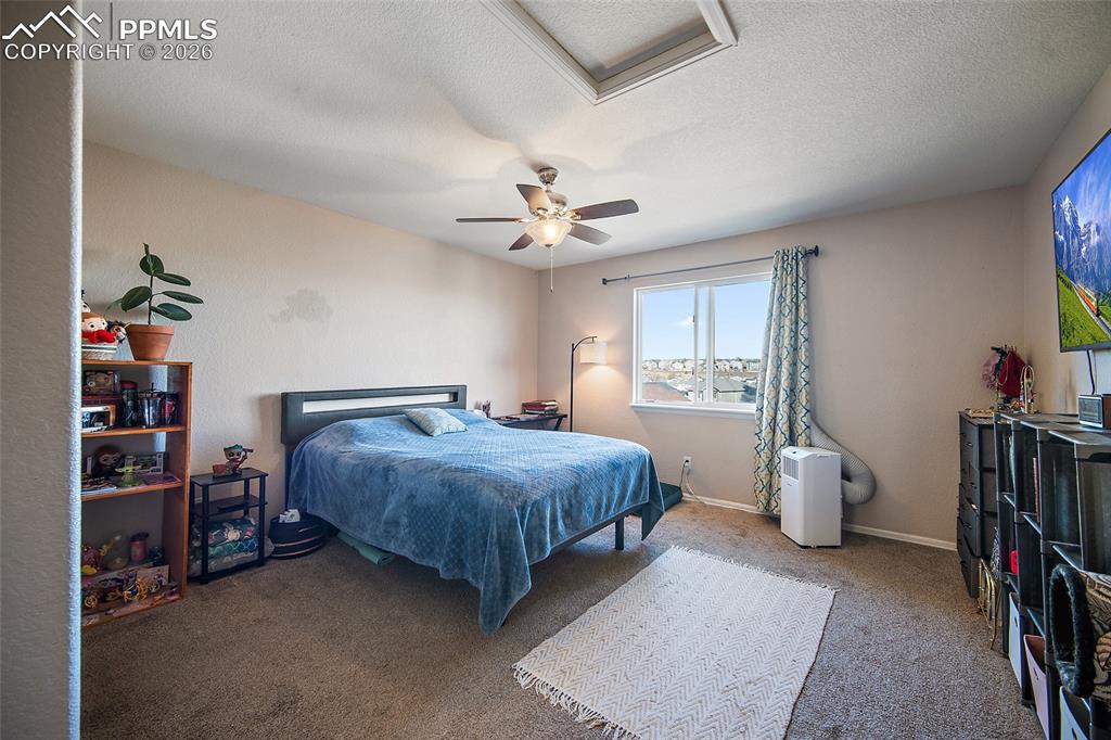 Image 16 of 47: Primary bedroom with a ceiling fan