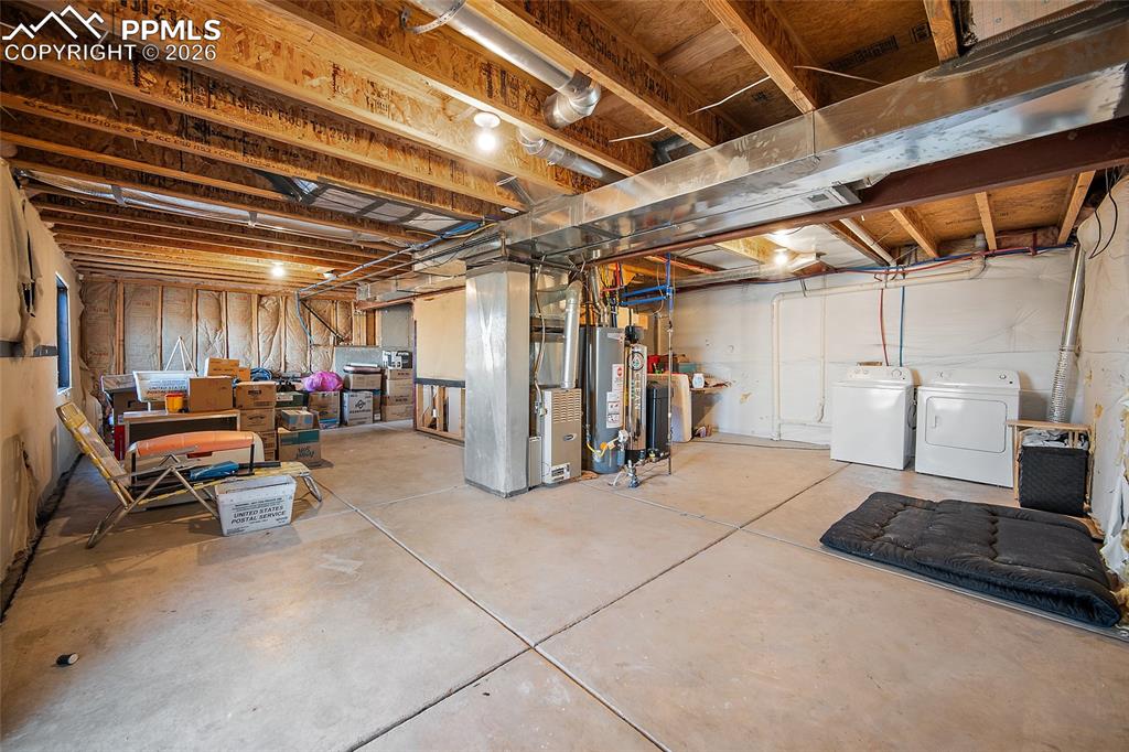 Image 30 of 47: Unfinished basement featuring furnace, water heater, washer & dryer and wat