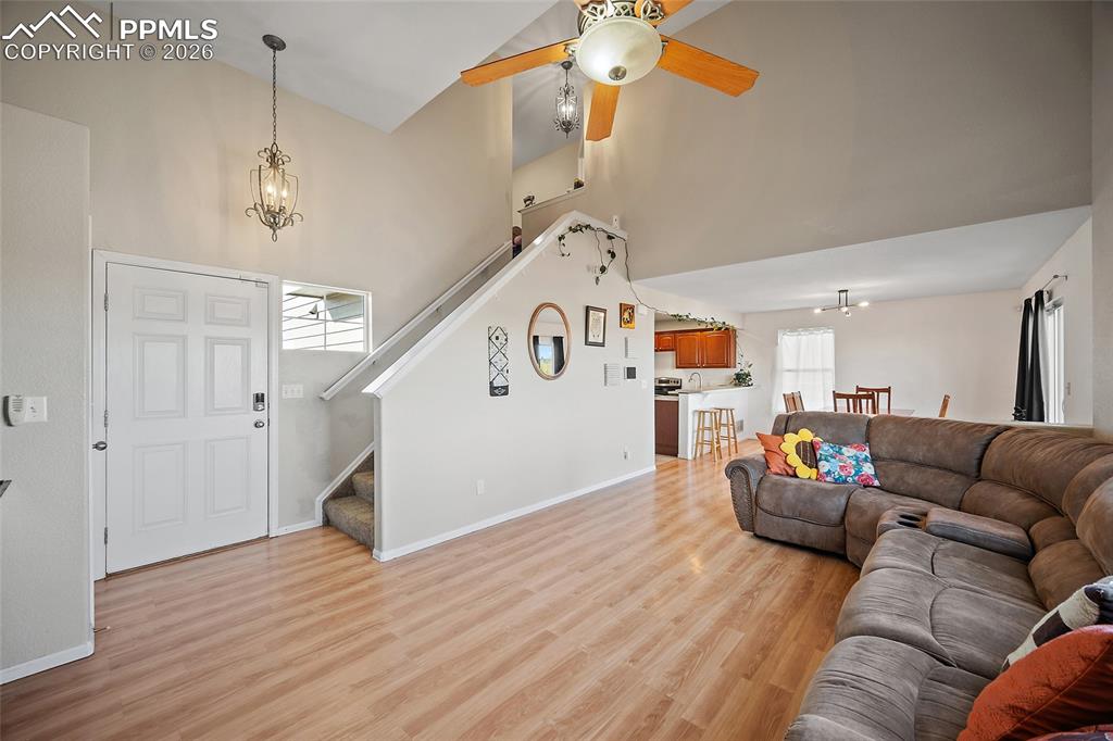 Image 4 of 47: Living room featuring a ceiling fan and vaulted ceilings