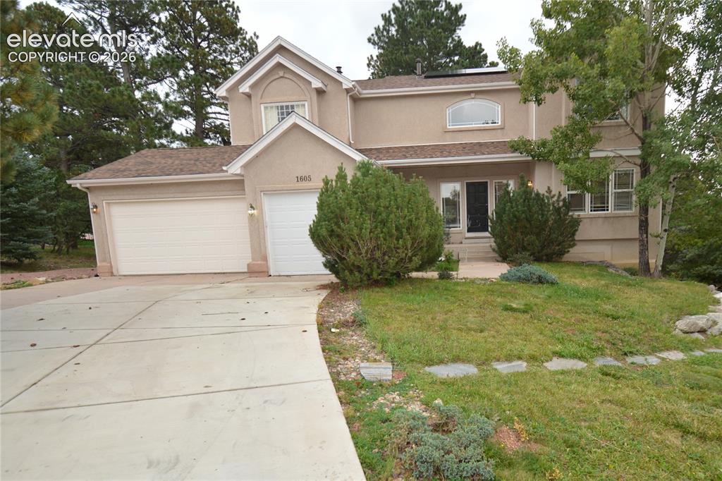 Caption: Circular driveway with 3 car garage