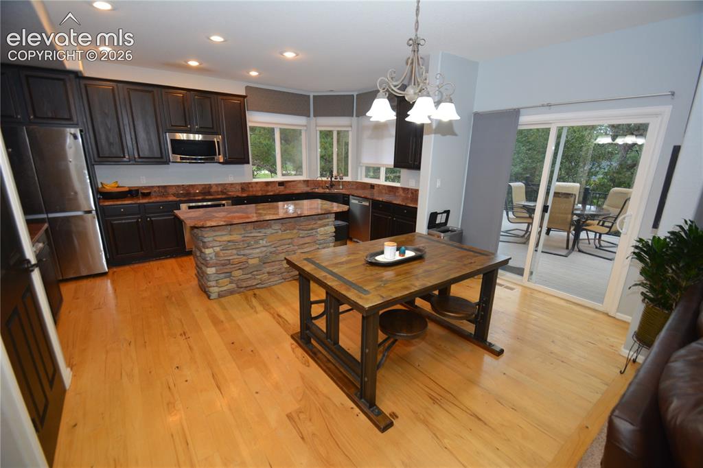 Image 12 of 48: Eat in Kitchen with island, granite countertops and stainless steel applian