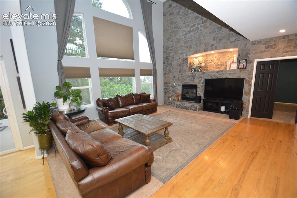 Image 16 of 48: Main level family room with gas fireplace. Looking from eat in kitchen towa