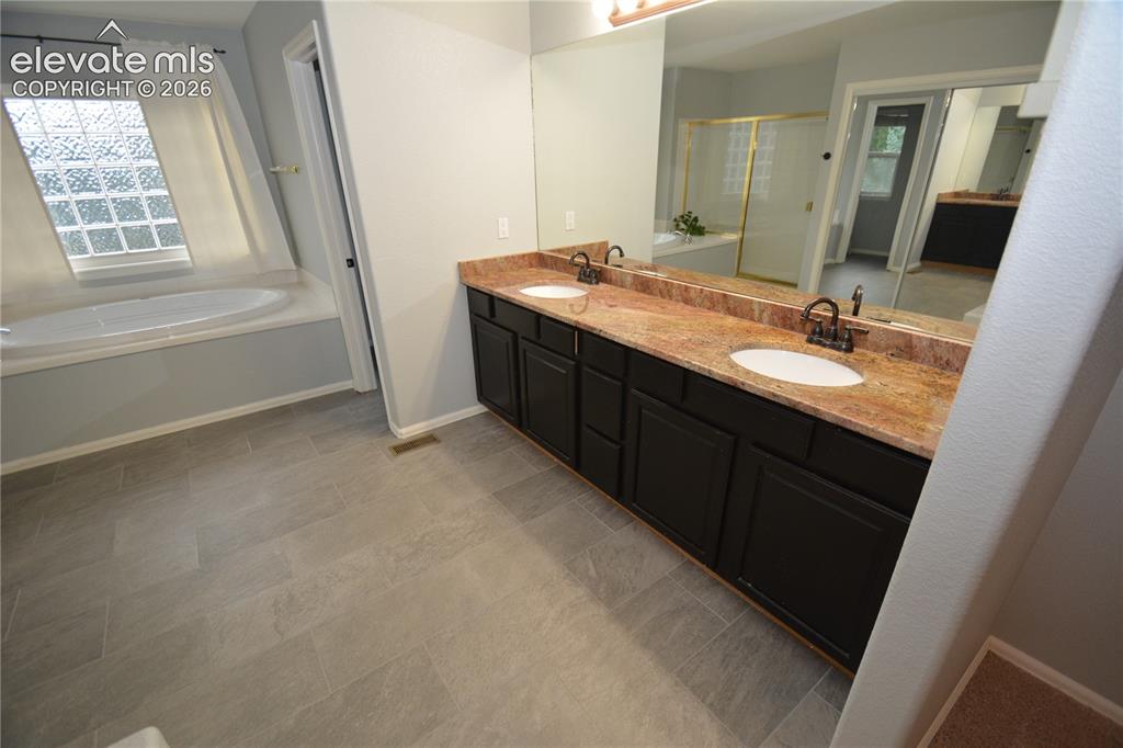 Image 28 of 48: primary bath.  double vanity.