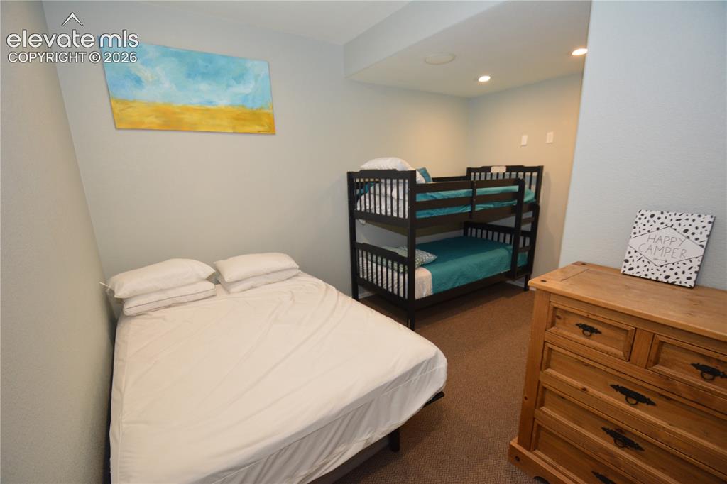 Image 45 of 48: Work-out room in basement, currently used as a bunk room.