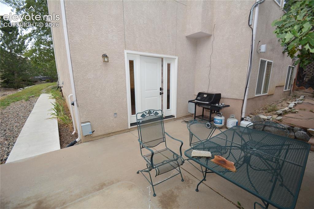 Image 46 of 48: back patio and private entrance to basement.