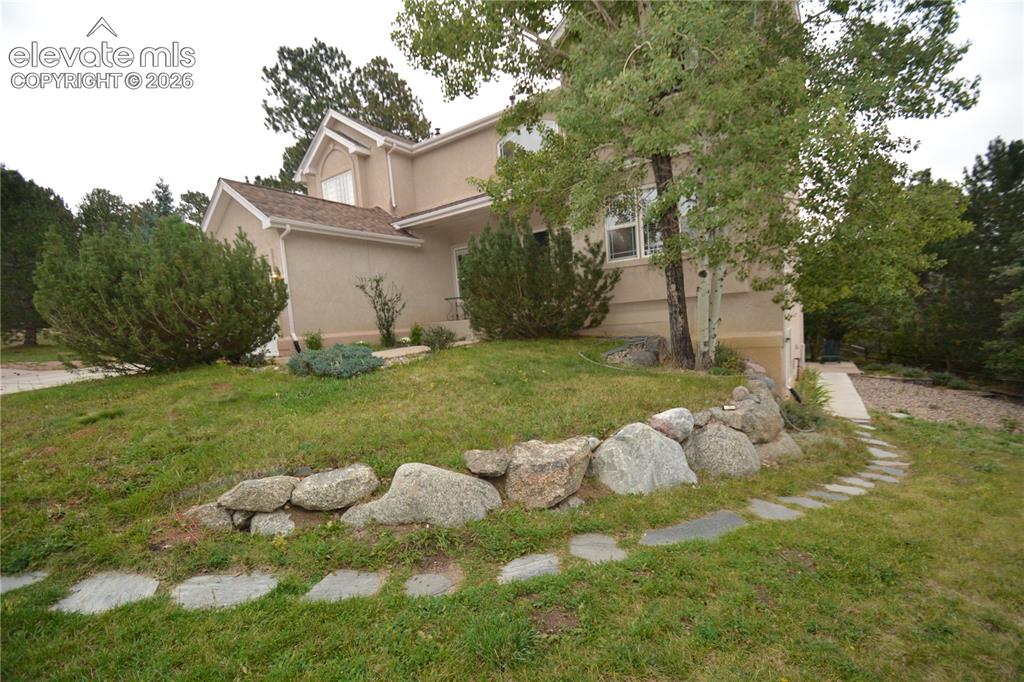 Image 47 of 48: Walk way from driveway to private basement entrance.