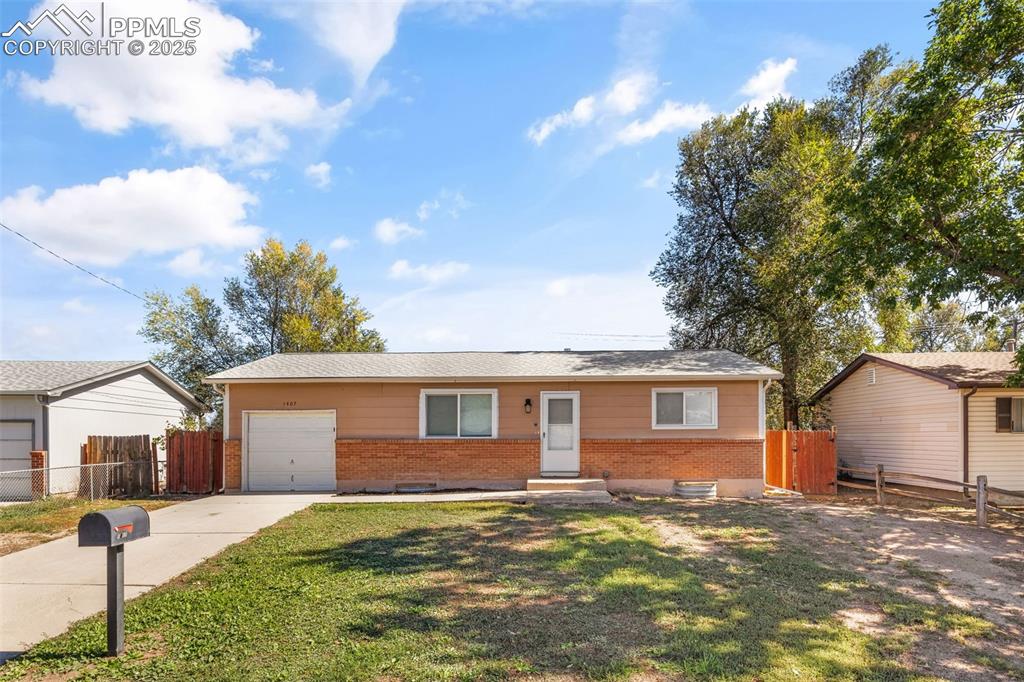 Caption: Ranch-style home with brick siding and driveway