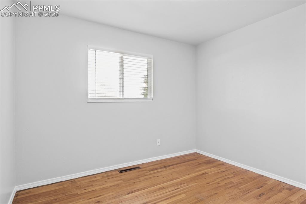 Image 16 of 25: Empty room featuring wood finished floors