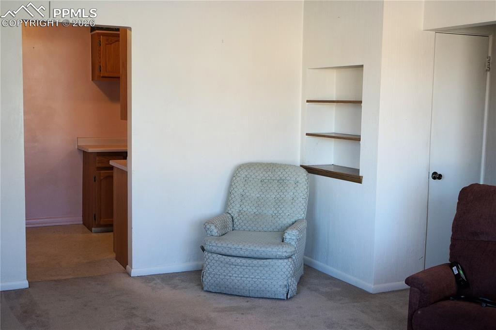 Image 3 of 40: Livingroom with Built-in shelving.