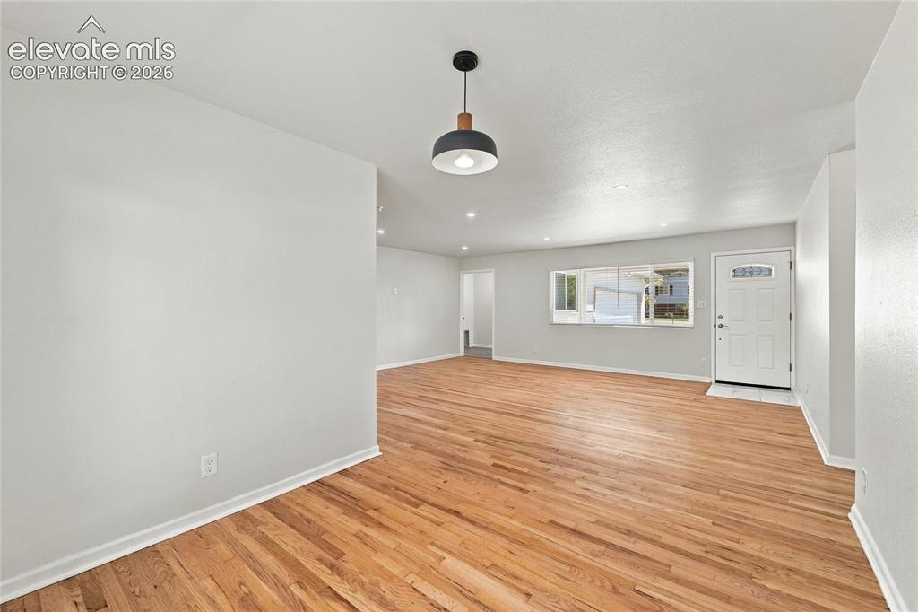 Image 13 of 49: Expansive room featuring wood flooring, recessed lighting, and a modern pen