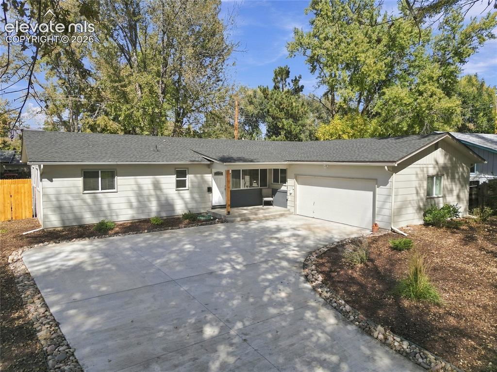 Image 2 of 49: Ranch-style exterior with a concrete driveway, attached garage, and a cover