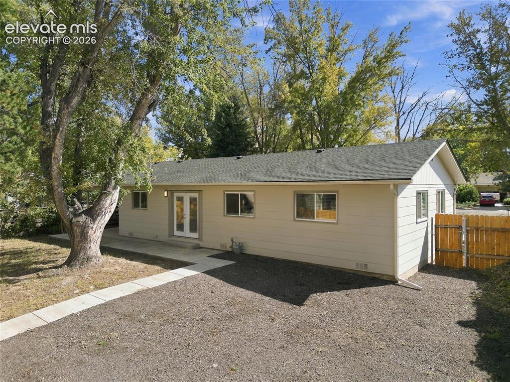 Image 37 of 49: Single-story residence featuring light-colored siding, a dark shingle roof,