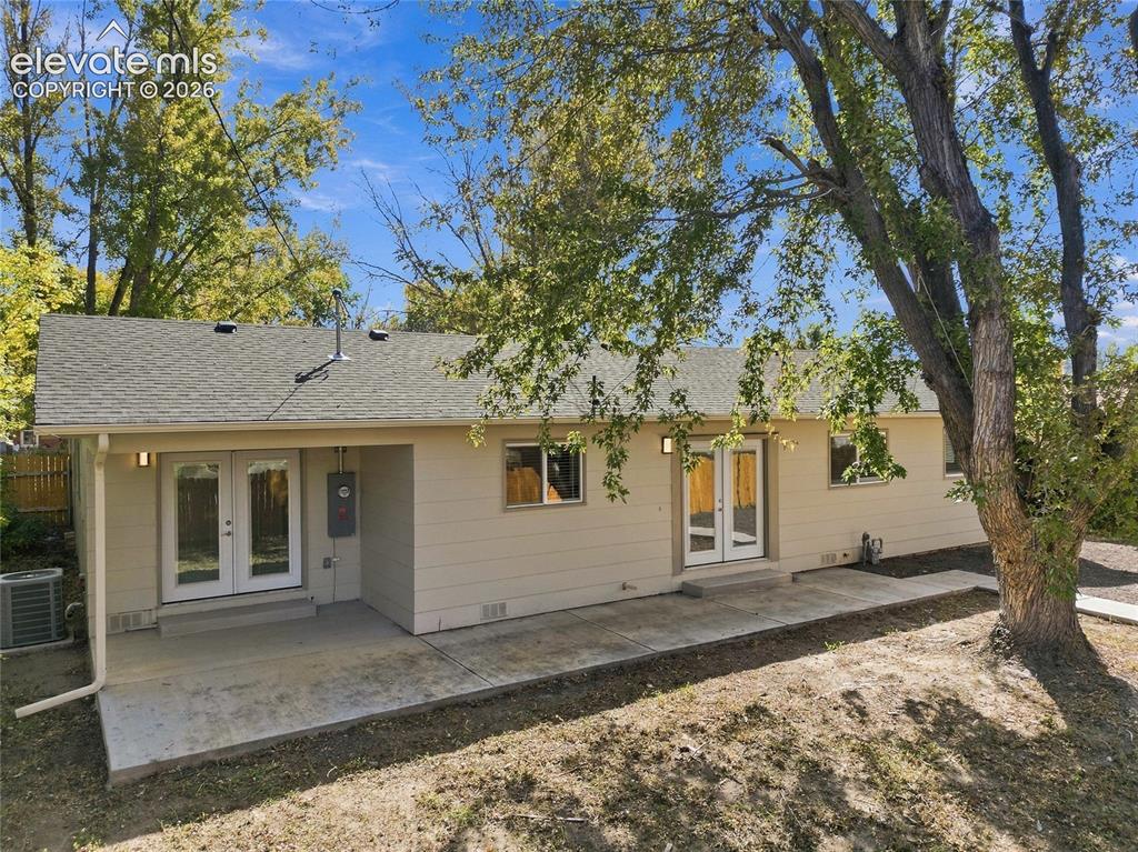 Image 38 of 49: Rear exterior featuring a covered patio, additional patio space, and dual F