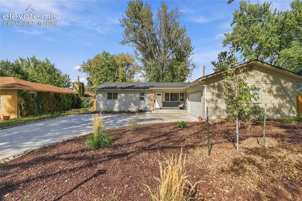 Image 39 of 49: Ranch-style exterior with a gabled roofline and an attached garage