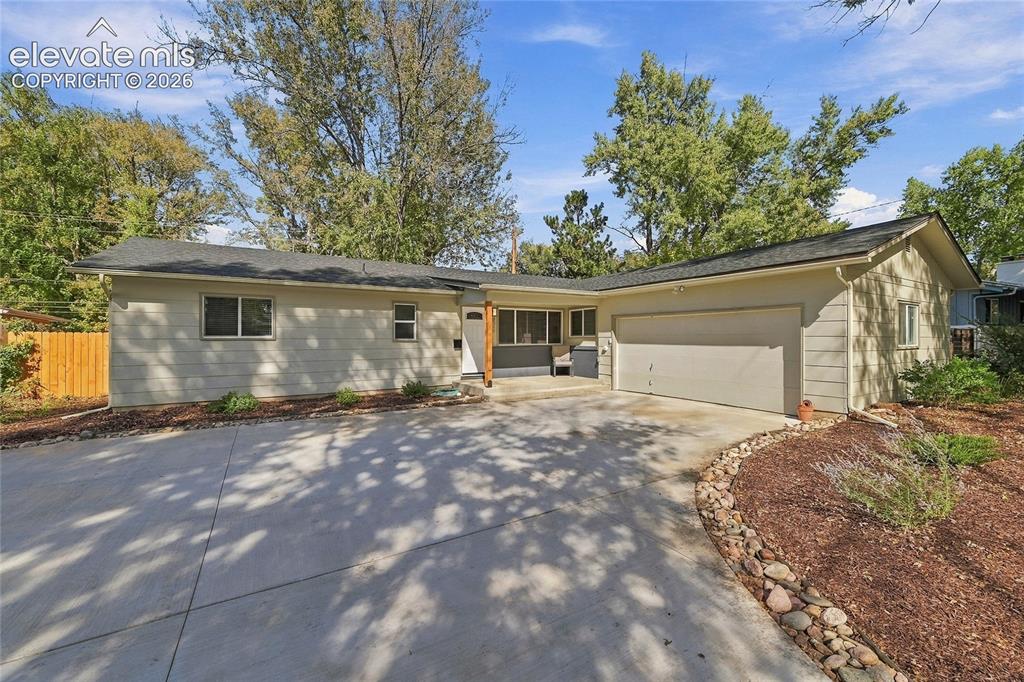 Image 41 of 49: Concrete driveway with attached garage