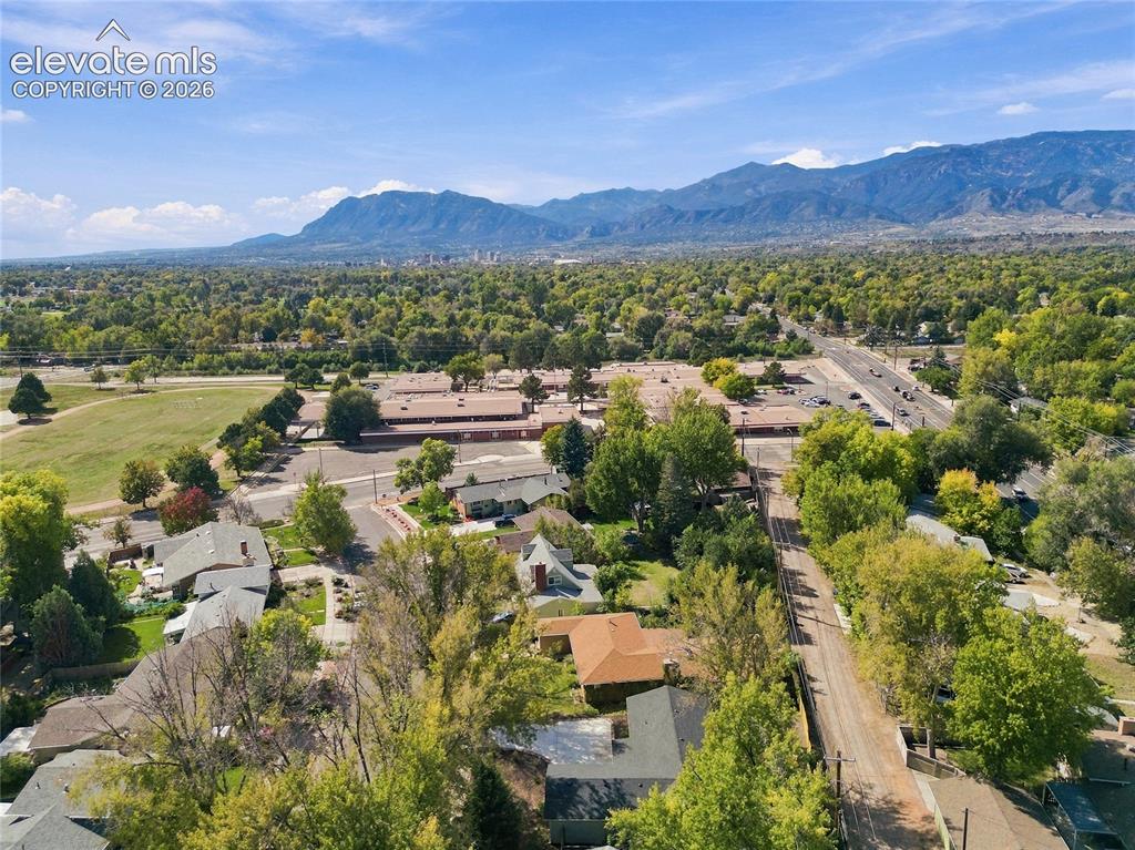 Image 46 of 49: Mountain backdrop, expansive treed landscape, nearby open green space, and 