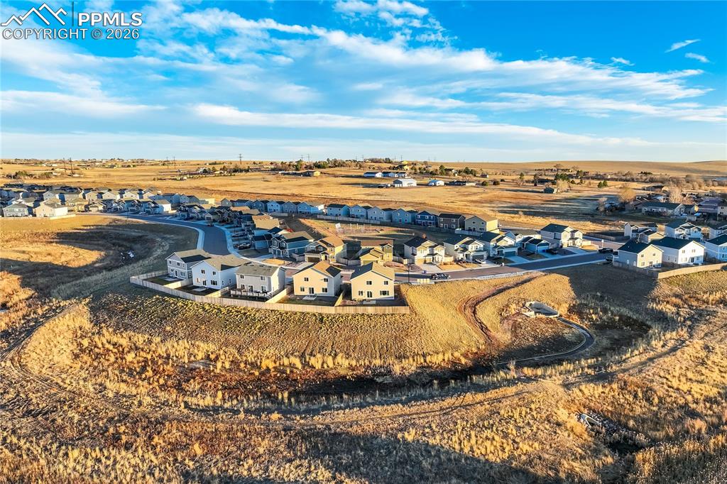 Image 38 of 45: Open space behind home with trails.