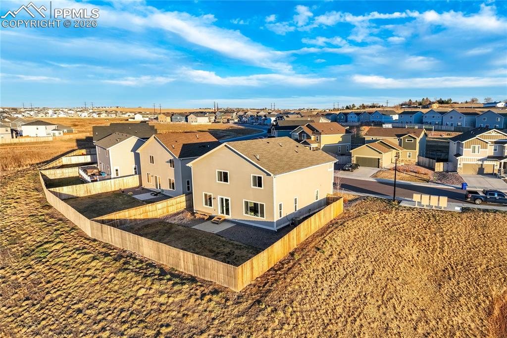 Image 39 of 45: Open space behind home with trails.