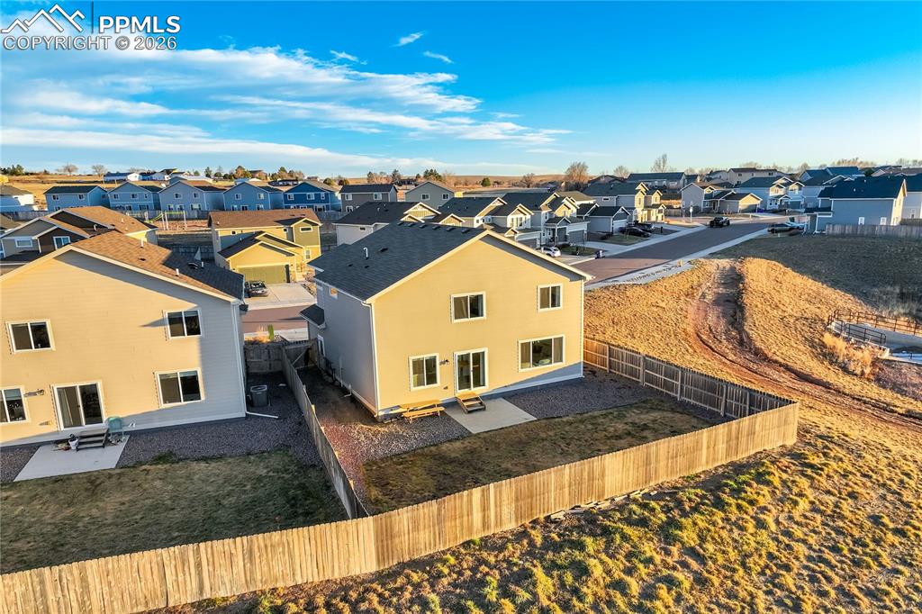 Image 40 of 45: Open space behind home with trails.