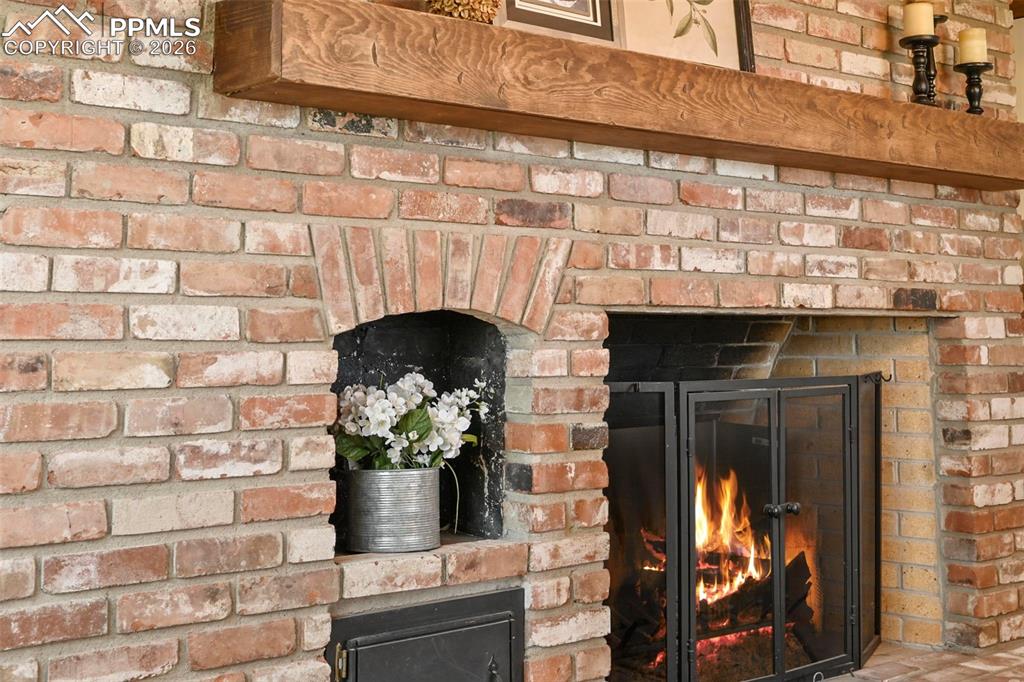 Image 12 of 50: Brick feature fireplace.