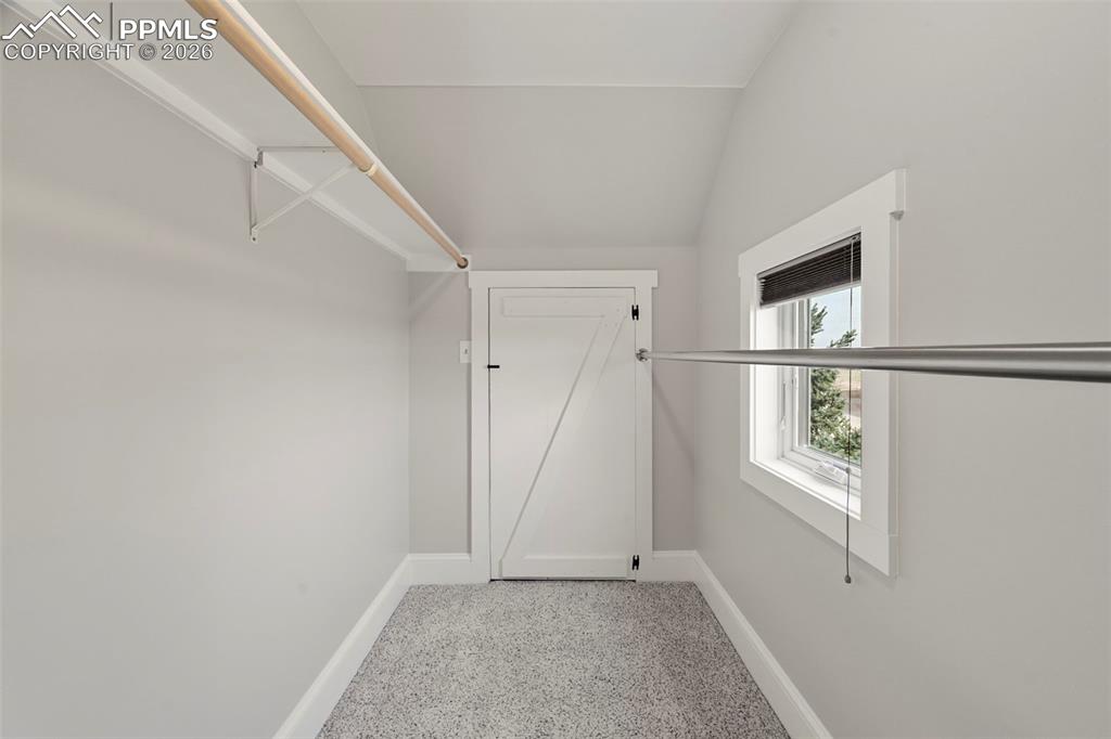Image 23 of 50: Second bed walk-in closet with attic closet door at the end
