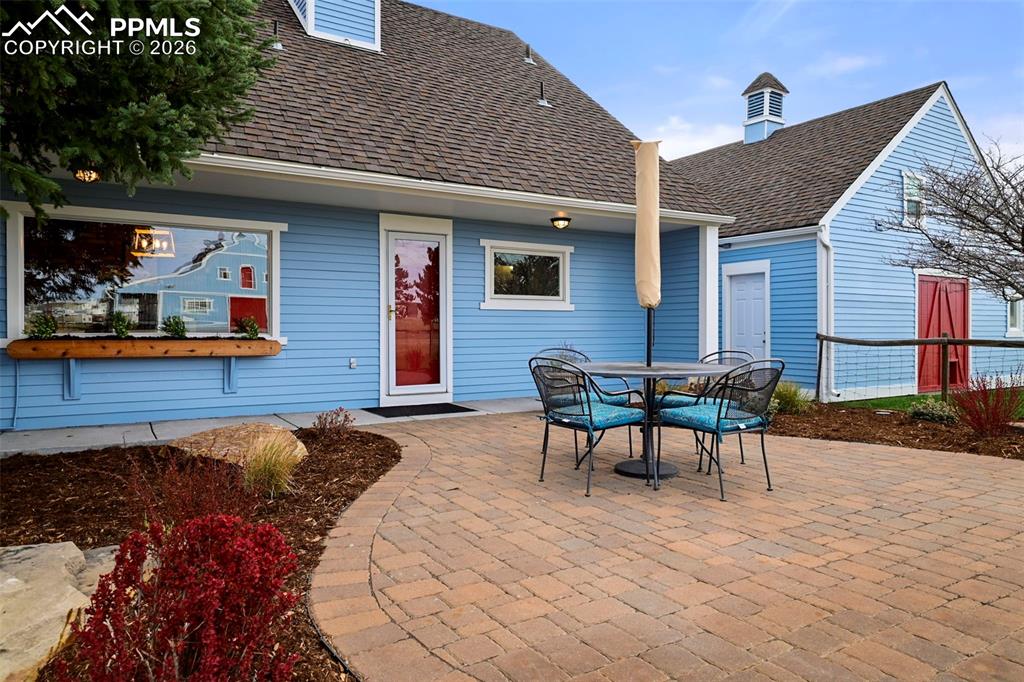 Image 28 of 50: Back Paver patio- orientation makes it shaded from the afternoon sun