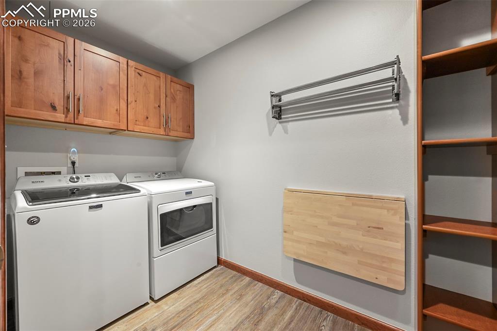 Image 35 of 50: Thoughtfully designed with storage and folding and hanging areas