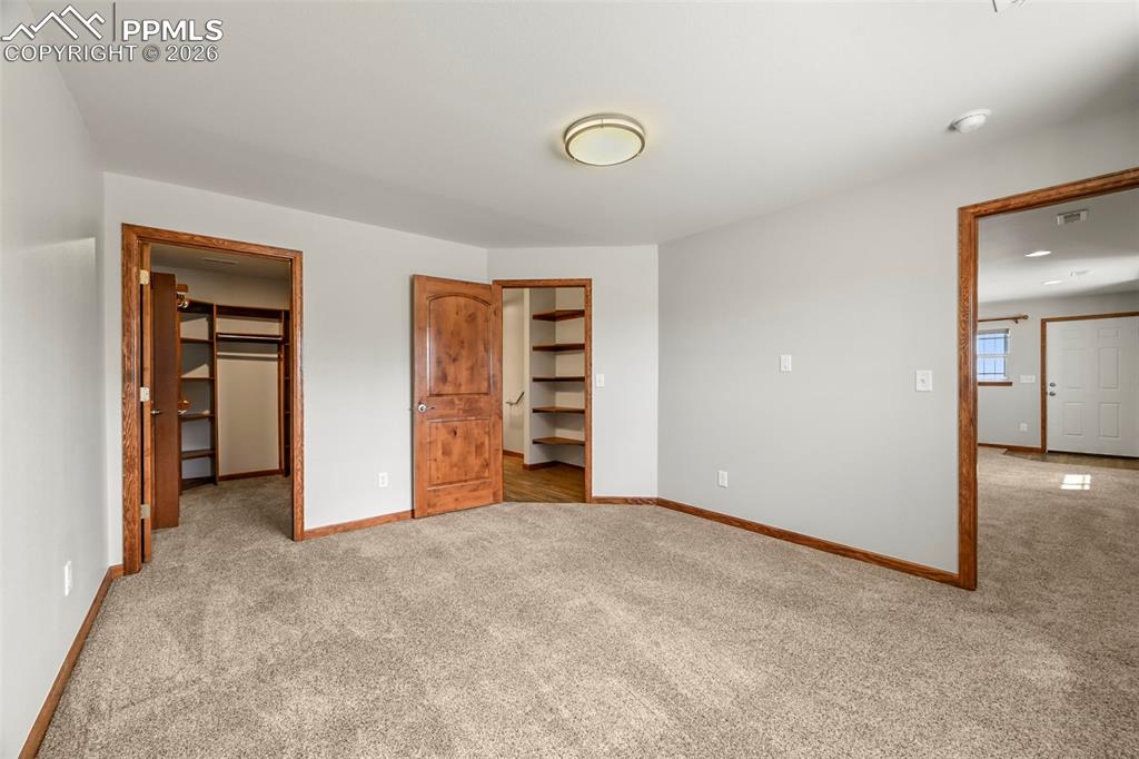 Image 37 of 50: Barndo Bedroom- access bath, livingroom, and walk-in closet.