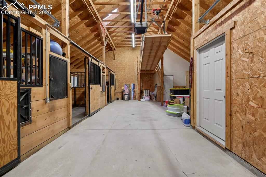 Image 41 of 50: Barn interior layout: stalls, storage, mechanized stairs for attic access.