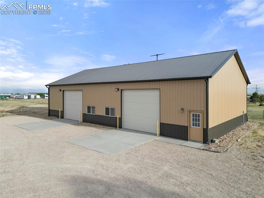 Image 44 of 50: Mezzanine shop: 14ft garage doors